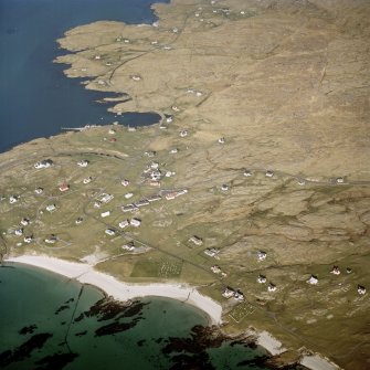 Oblique aerial view centred on the burial grounds with the harbour adjacent, taken from the WSW.