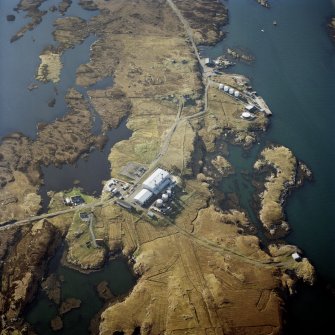 Oblique aerial view centred on the power station, with the jetty and township adjacent, taken from the ESE.