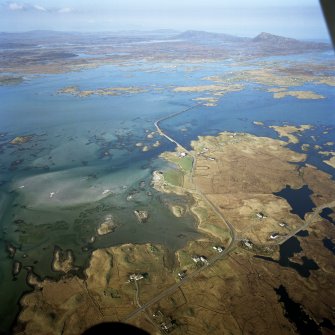 General oblique aerial view centred on the causeway, looking across Grimsay towards Eavel in the distance, taken from the SW.
