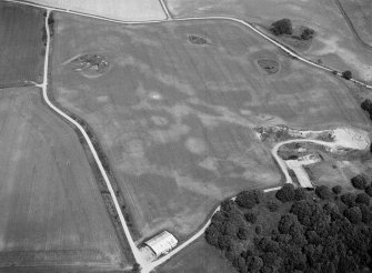 Oblique aerial view centred on the cropmarks of the timber hall, ring ditch, enclosures and pits at Mondobbo House, looking to the NNW.