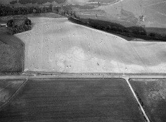 Oblique aerial view centred on the cropmarks of the circular enclosure at Barflat, looking to the ESE.