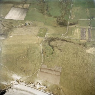 Oblique aerial view centred on the site of the chapel and burial ground with the burial ground adjacent, taken from the NW.