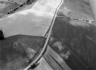 Oblique aerial view centred on the cropmarks of the circular enclosure at Barflat with the cropmarks of the possible square barrows adjacent, looking to the SSW.

