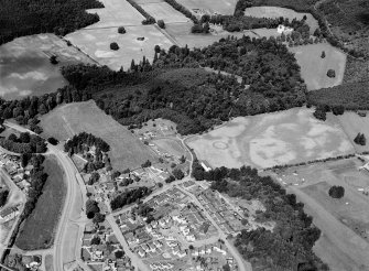 Oblique aerial view centred on the cropmarks of the palisaded enclosure, linear features, pits and rig at Heogan and East Mains of Aboyne, looking to the NNE.

