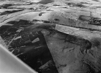Oblique aerial view centred on the remains of Brown Caterthun fort, looking to the NNE.