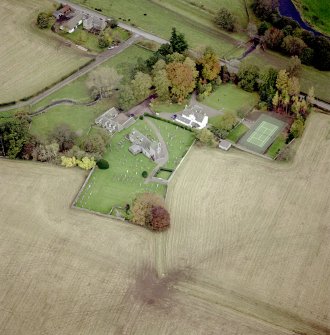 Oblique aerial view centred on the church and house, taken from the WNW.