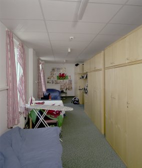 Interior view of 1935 Barrack Block showing first floor dormitory with beds and storage cupboards from N.