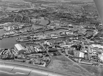 Oblique aerial view centred on Aberdeen harbour and the River Dee, looking to the SW.