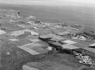 General oblique aerial view centred on Den of Boddam reservoir, flint mines and lithic working site, looking to the NE.