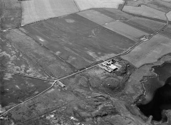 Oblique aerial view centred on Old Rattray farmstead with St Mary's Chapel adjacent, looking to the SE.