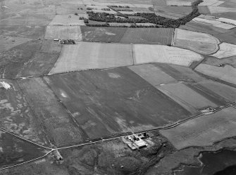 Oblique aerial view centred on Old Rattray farmstead with St Mary's Chapel adjacent, looking to the SSE.
