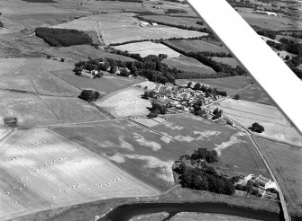 Oblique aerial view centred on the cropmarks of the barrow at Boat of Hatton with the burial ground and Hatton of Fintray adjacent, looking to the NE.