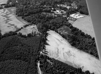 Oblique aerial view centred on the cropmarks of the timber hall and pit alignment at Crathes, looking to the WNW.