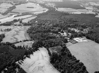 Oblique aerial view centred on the cropmarks of the timber hall and pit alignment at Crathes, looking to the WSW.