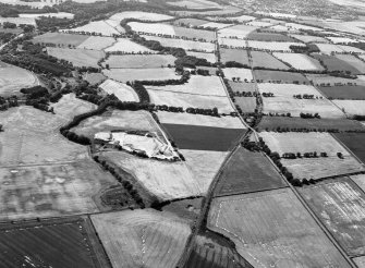 Oblique aerial view centred on the cropmarks of the unenclosed settlement, ring ditches, souterrain, pit alignment, rig and linear features at Arrat's Mill, looking to the W.