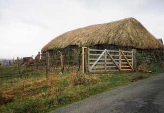 View of thatched cottage.