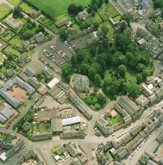 Oblique aerial view centred on the church, taken from the N.  Also visible is Kelso Abbey.