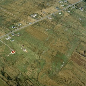 Oblique aerial view centred on the township and the remains of the buildings, taken from the SW.