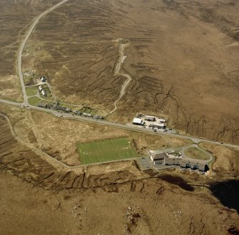 Oblique aerial view centred on the school and houses, taken from the ESE.
