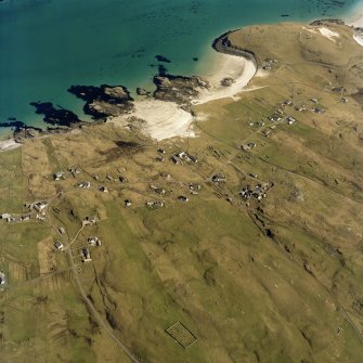 Oblique aerial view centred on the townships and the remains of the buildings with the burial ground adjacent, taken from the W.