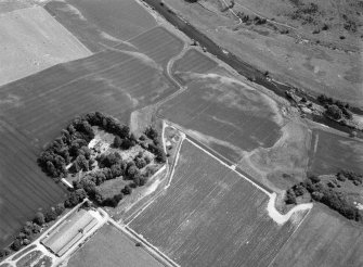 Oblique aerial view centred on the cropmarks of the unenclosed settlement, ring ditches, possible roundhouses and pits at Auldtown of Netherdale, looking to the E.