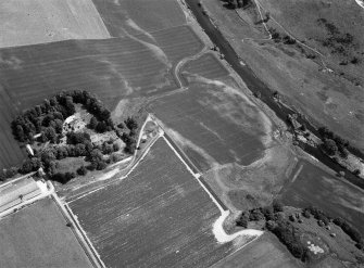 Oblique aerial view centred on the cropmarks of the unenclosed settlement, ring ditches, possible roundhouses and pits at Auldtown of Netherdale, looking to the ENE.