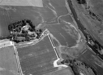 Oblique aerial view centred on the cropmarks of the unenclosed settlement, ring ditches, possible roundhouses and pits at Auldtown of Netherdale, looking to the ENE.