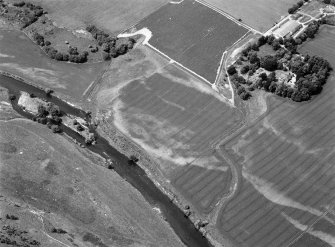 Oblique aerial view centred on the cropmarks of the unenclosed settlement, ring ditches, possible roundhouses and pits at Auldtown of Netherdale, looking to the WNW.