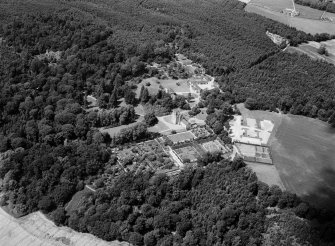 Oblique aerial view centred on Crathes Castle and gardens with the cropmarks of the pit alignment and timber hall adjacent, looking to the NNW.