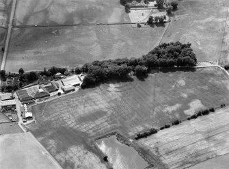 Oblique aerial view centred on the cropmarks of the fort, ring ditch and rig at Mains of Edzell with the farmstead adjacent, looking to the WSW.