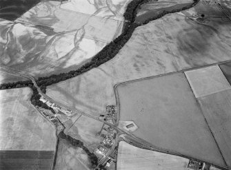 Oblique aerial view centred on the cropmarks of the pit defined cursus, unenclosed settlement, ring ditches, pits and rig with Stracathro Roman Fort and Temporary Camp adjacent at Inchbare North, looking to the NE.