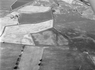 Oblique aerial view of the cropmarks of the enclosure, unenclosed settlement and other cropmarks at Myreside, looking to the SE.