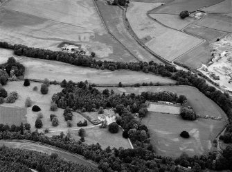General oblique aerial view centred on Pitcaple Castle with the cropmarks of the enclosure and rig adjacent at Riverbank Wood, looking to the NNW.