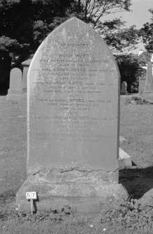 Digital copy of photograph of headstone commemorating Hugh Watt, d.1871, his wife Agnes Darge, d.1972, John Watt, their son, d.1831, Agnes, their daughter, d.1871, their son John Darge Watt, d.1914 and his wife Barbara Horsburgh, d.1939.
Survey no. 57
