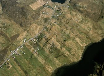 Oblique aerial view centred over the township and the remains of the buildings, taken from the SW.