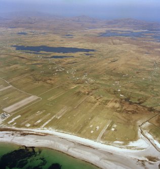 General oblique aerial view looking across the crofting townships of South Boisdale and North Boisdale towards Lochboisdale in the distance, taken from the SW.