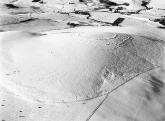 Oblique aerial view centred on the remains of the fort at Brown Caterthun, looking to the NW.