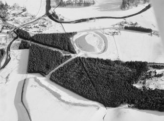 Oblique aerial view centred on the remains of the motte at Doune of Invernochty, looking to the SE.