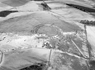 Oblique aerial view centred on the remains of the fort and rig and furrow at Barra Hill, looking to the ESE.