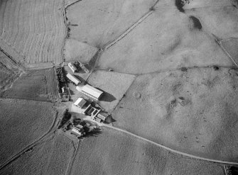 Oblique aerial view centred on the remains of cairns and enclosures at Cluseburn, looking to the NNE.