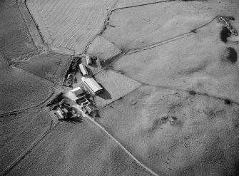 Oblique aerial view centred on the remains of cairns and enclosures at Cluseburn, looking to the NNW.