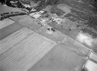 Oblique aerial view centred on the St Nathalan's Kirk and churchyard at Tullich with the souterrain at Braehead Farm adjacent, looking to the NW.