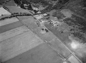 Oblique aerial view centred on the St Nathalan's Kirk and churchyard at Tullich with the souterrain at Braehead Farm adjacent, looking to the WNW.