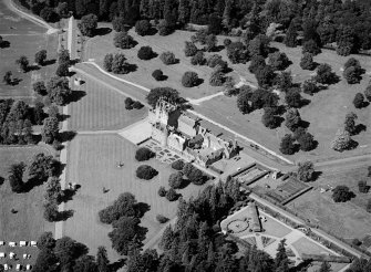 Oblique aerial view centred on Glamis Castle and policies, looking to the WNW.