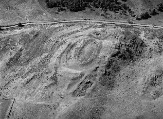 Oblique aerial view centred on the remains of the fort and rig at Barry Hill, looking to the WSW.