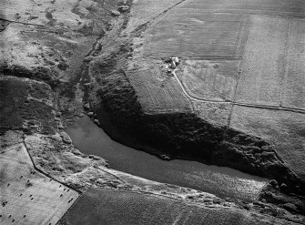 Oblique aerial view centred on the Den of Boddam reservoir, flint mines and lithic working site, looking to the WSW.