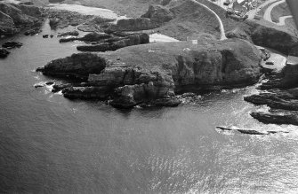 Oblique aerial view of Green Castle, Portnockie, looking to the SE.