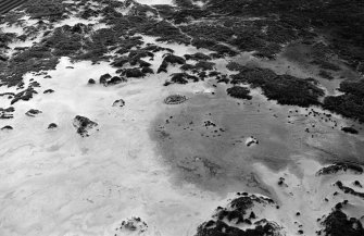 Oblique aerial view centred on the remains of hut circles and the midden at Sands of Forvie, looking to the NE.