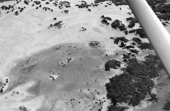 Oblique aerial view centred on the remains of hut circles and the midden at Sands of Forvie, looking to the NE.