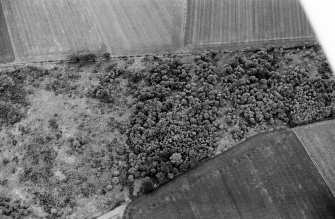 Oblique aerial view centred on the remains of a barrow at Midtown of Pitglassie, looking to the SE.